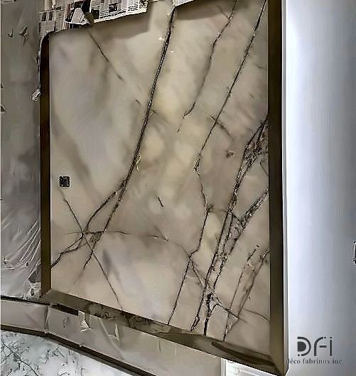 Brass frame around a book-matched marble feature wall