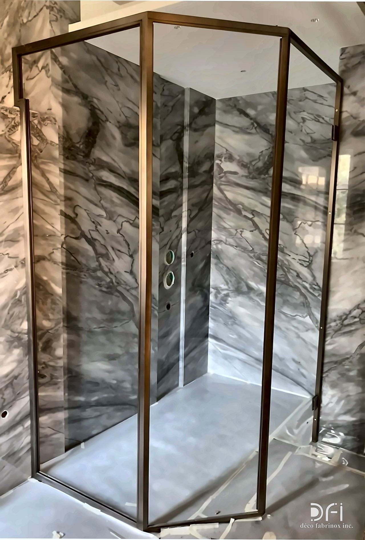 Bronze-framed corner shower enclosure in grey marble