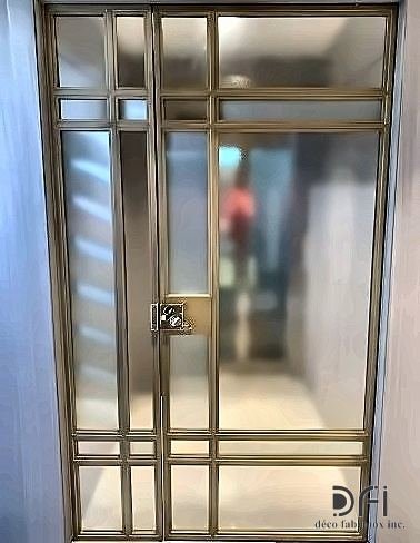 Brass grid entrance door with glazed panels