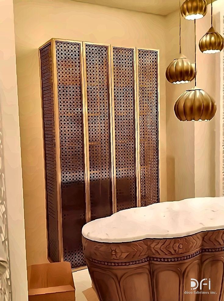 Brass mesh folding screen beside a carved bathtub in a hotel suite