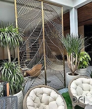 Brass palm-leaf screen on a hotel terrace