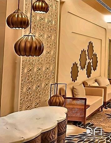 Brass perforated screens framing a hotel lounge seating area