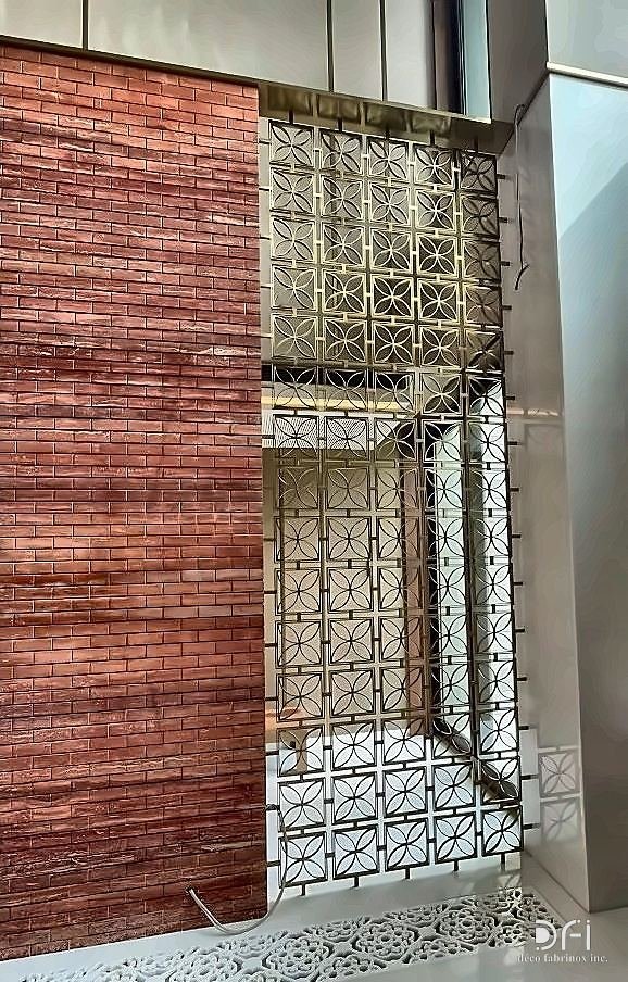 Brass screen over a window in a brick facade