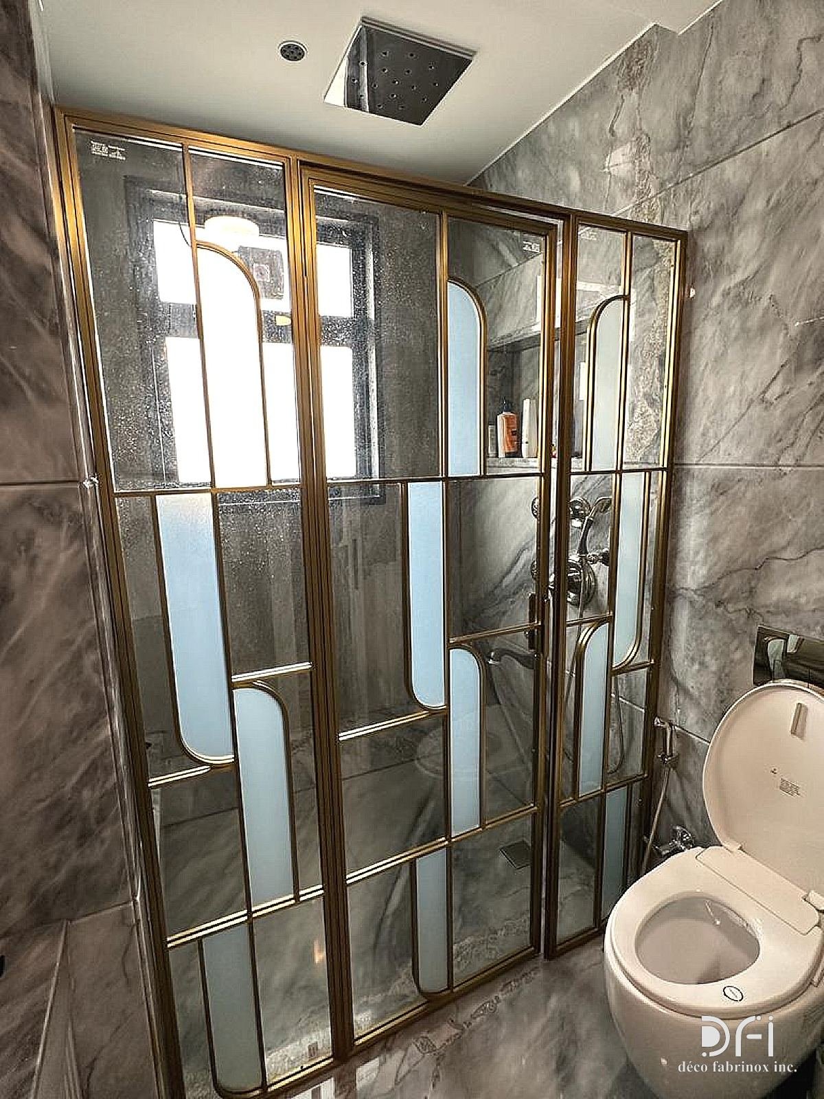 Brass shower enclosure with frosted panels, installed