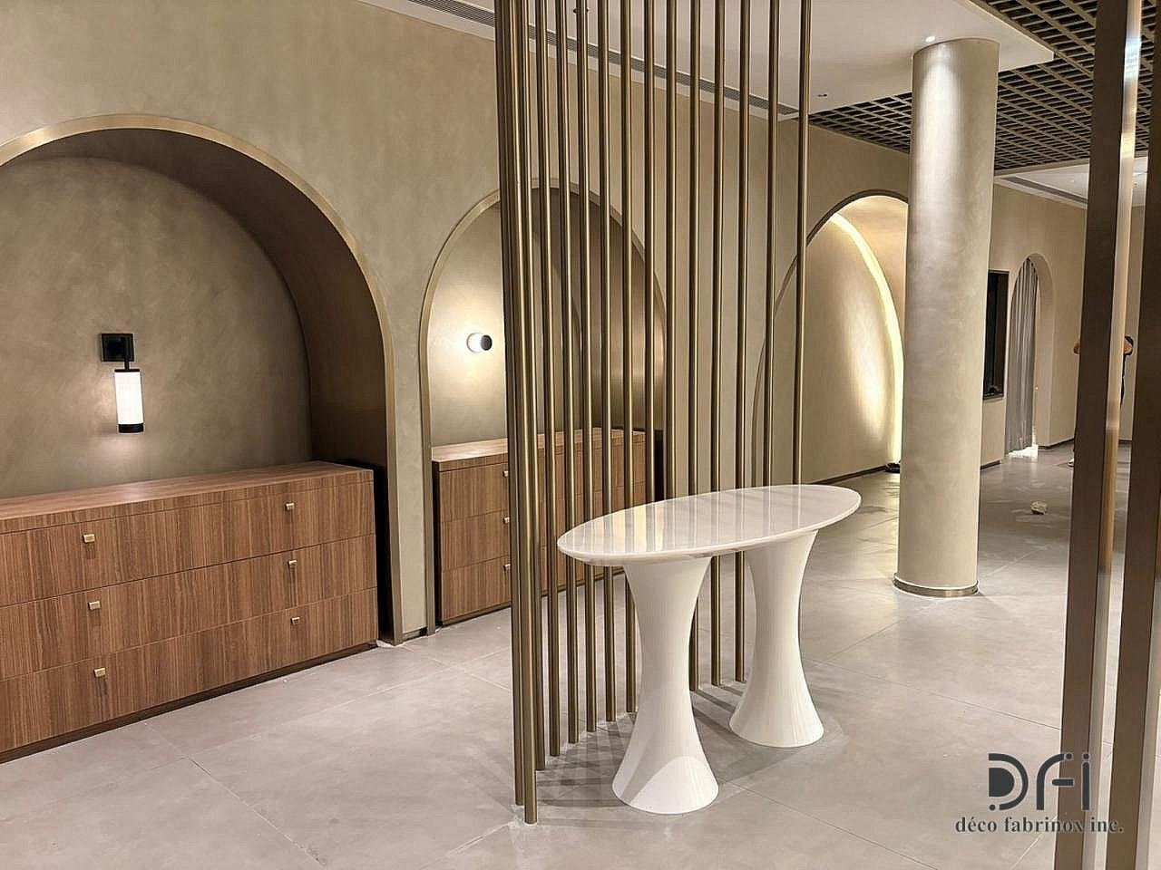 Brass slat screens and arched niches in a showroom