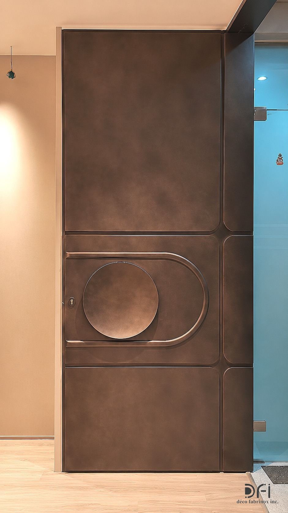 Bronze door with a moon-disc handle detail