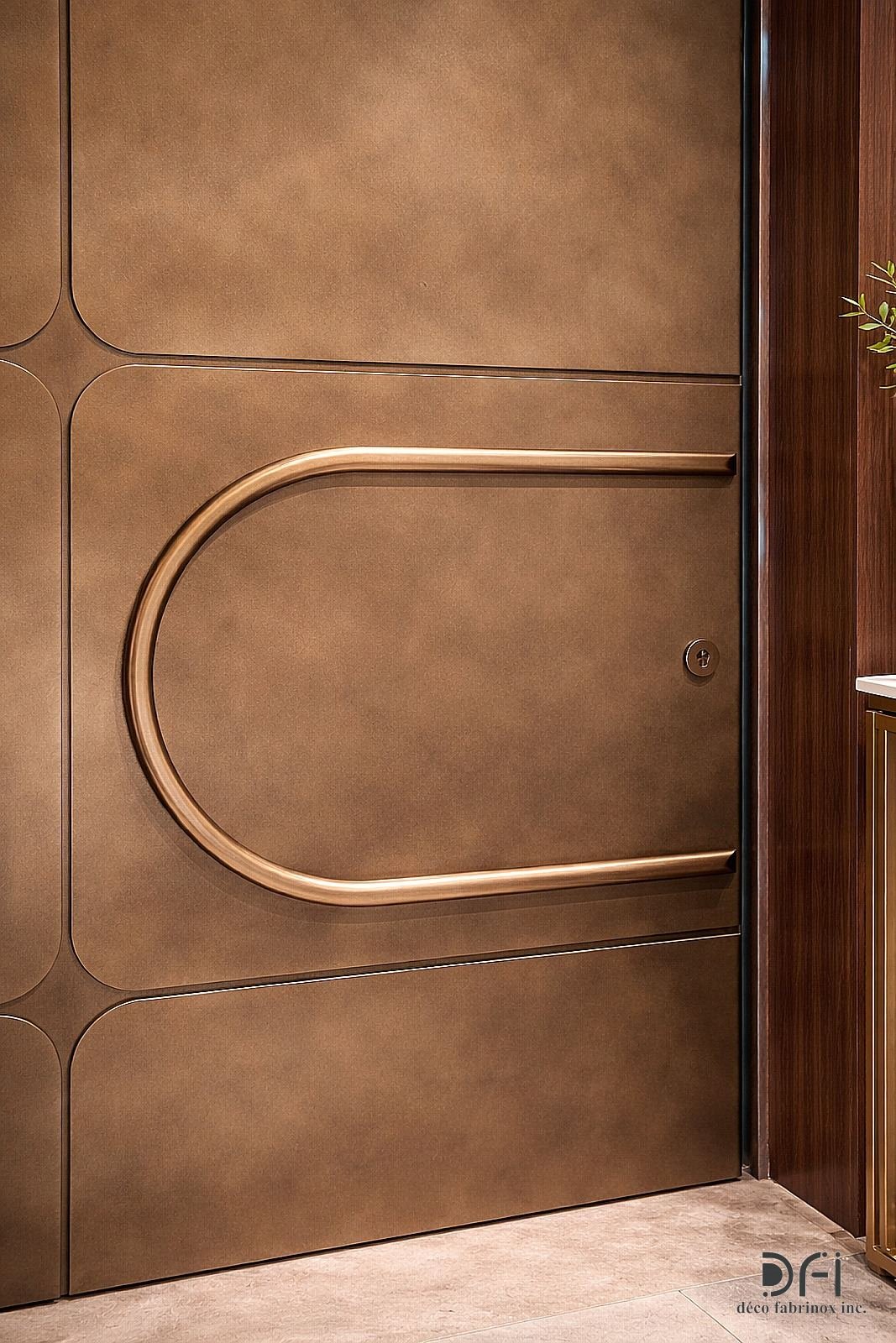 Bronze door with a sweeping U-shaped handle, close view