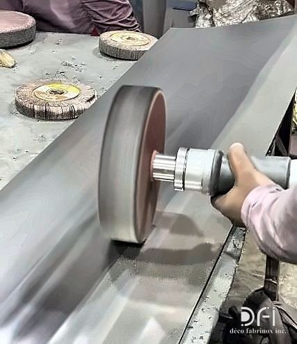 Buffing wheel polishing a metal surface by hand
