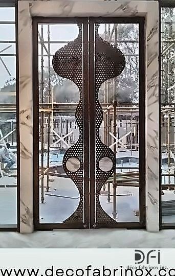 Copper laser-cut entrance door under installation