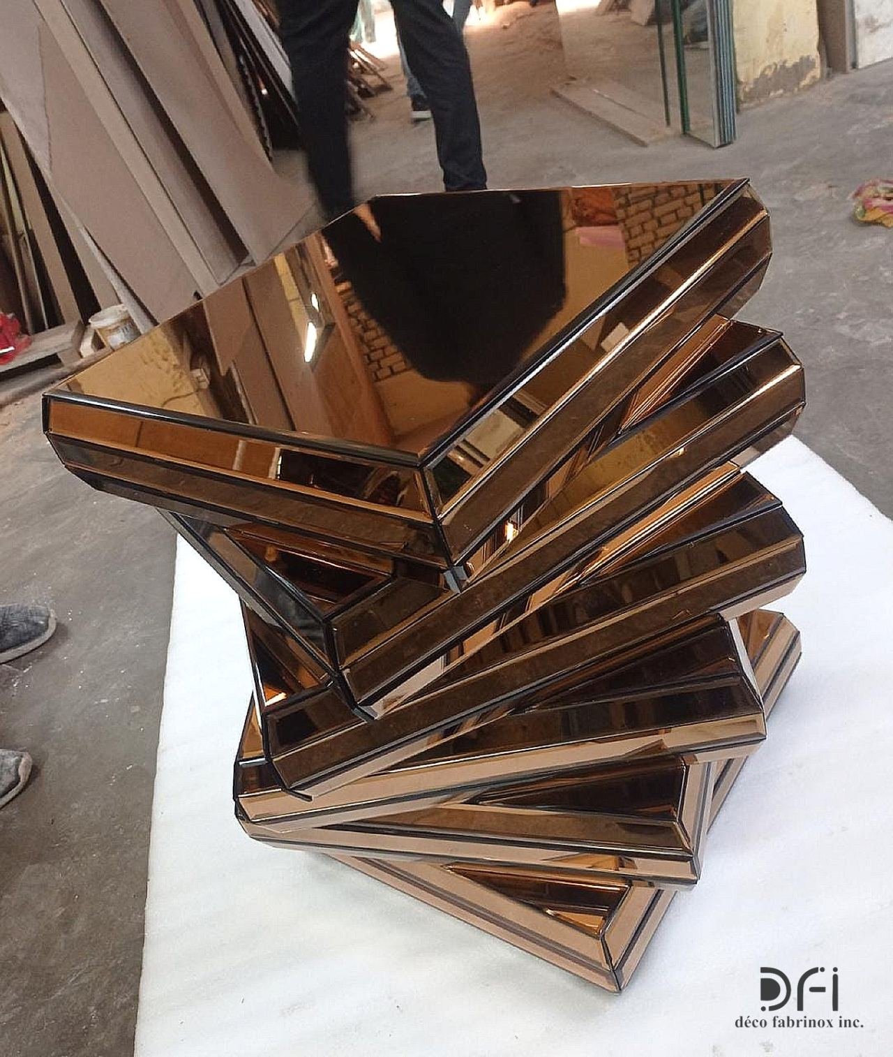 Twisted stack side table in copper-tinted mirror steel