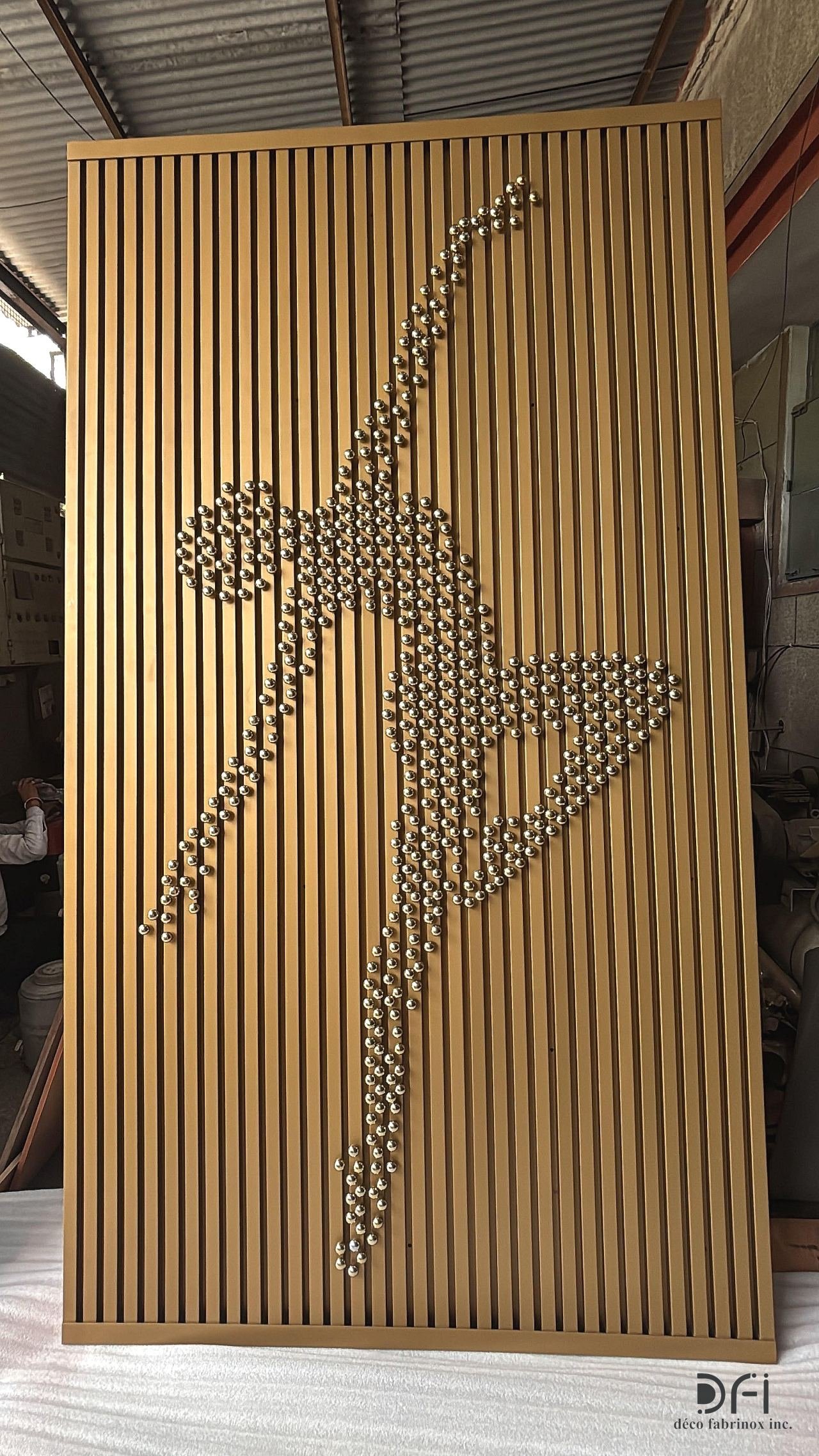Fluted gold dancer wall panel standing finished in the workshop