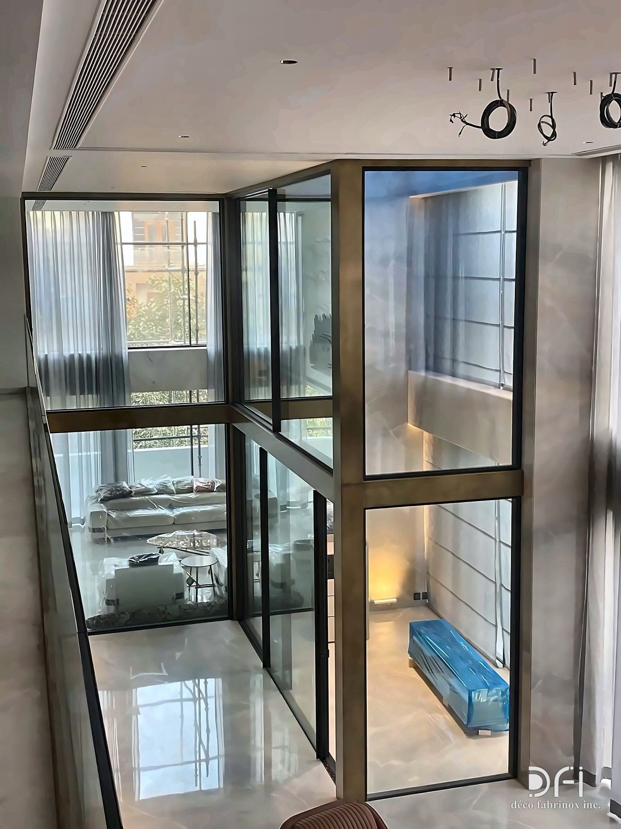 Bronze-framed glass partition around a stair