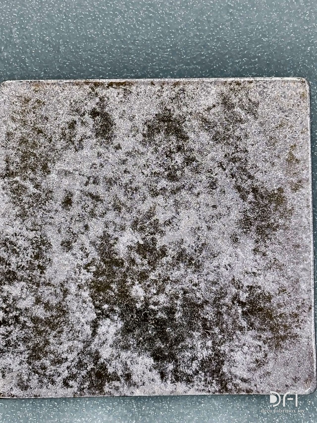Silver-grey finish sample with dark speckles