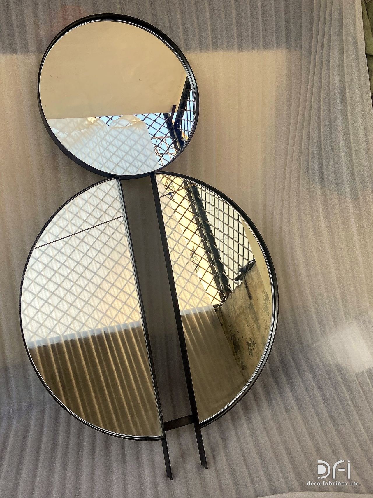 Double-circle black-framed mirror
