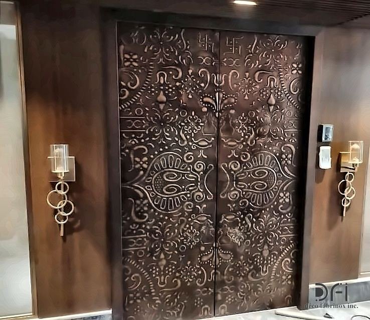 Embossed copper entrance doors to a residence