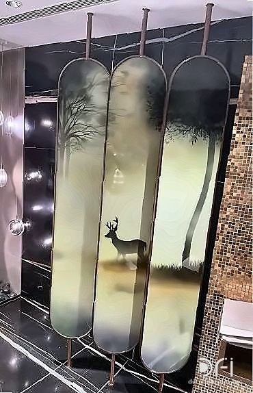 Etched metal wall panels in a dark bathroom