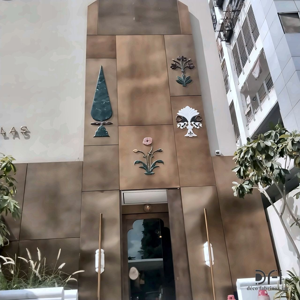 Bronze-clad facade with inlaid floral motifs at an entrance