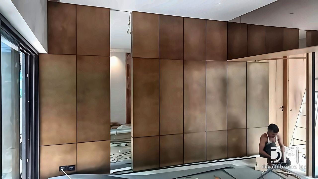 Bronze cladding panels on a long wall during installation