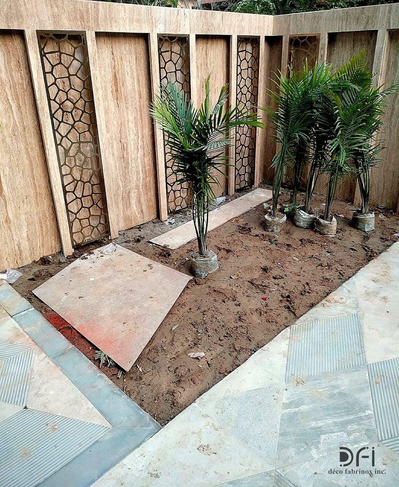 Laser-cut metal screens along a courtyard wall