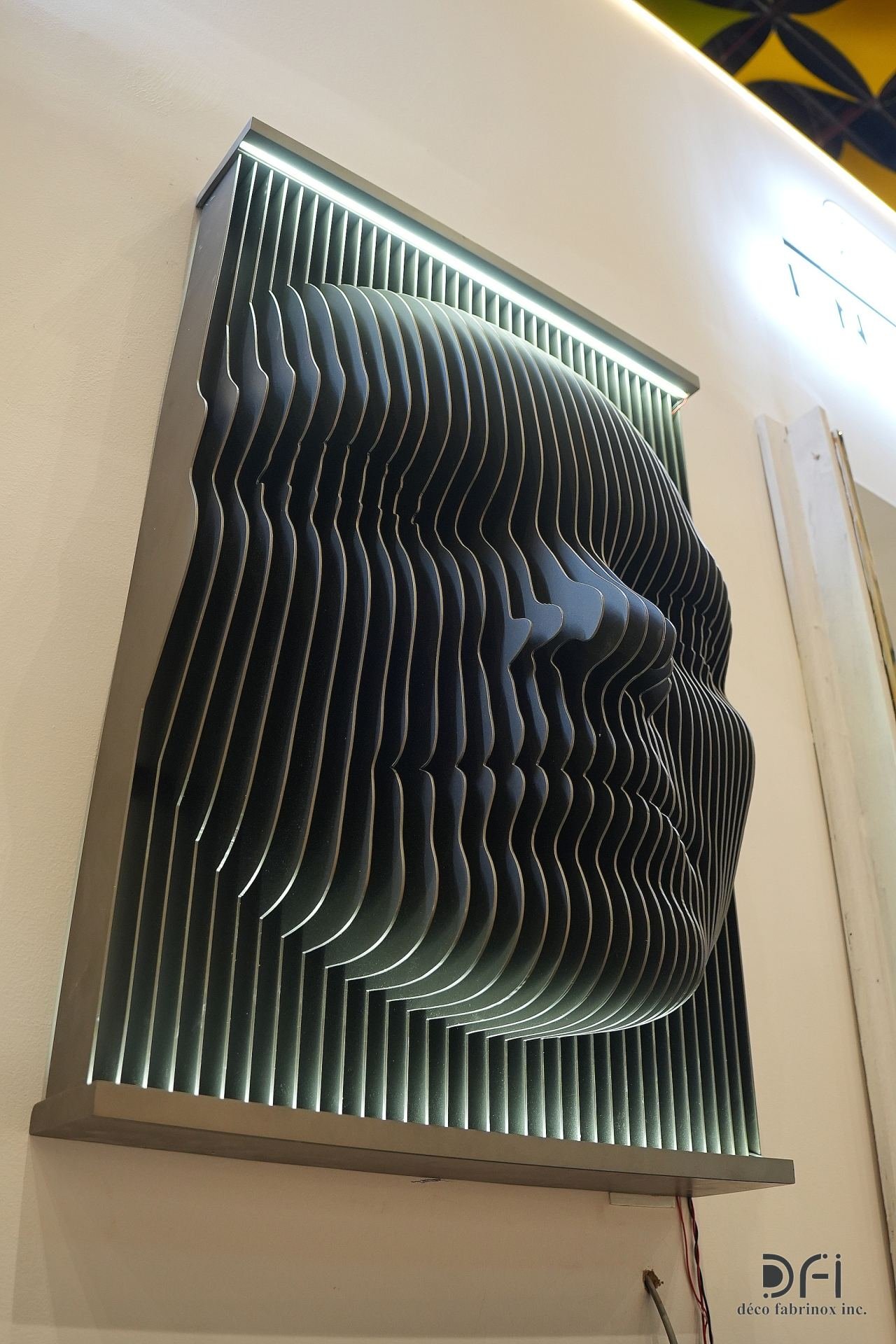 Layered steel face wall sculpture with backlighting