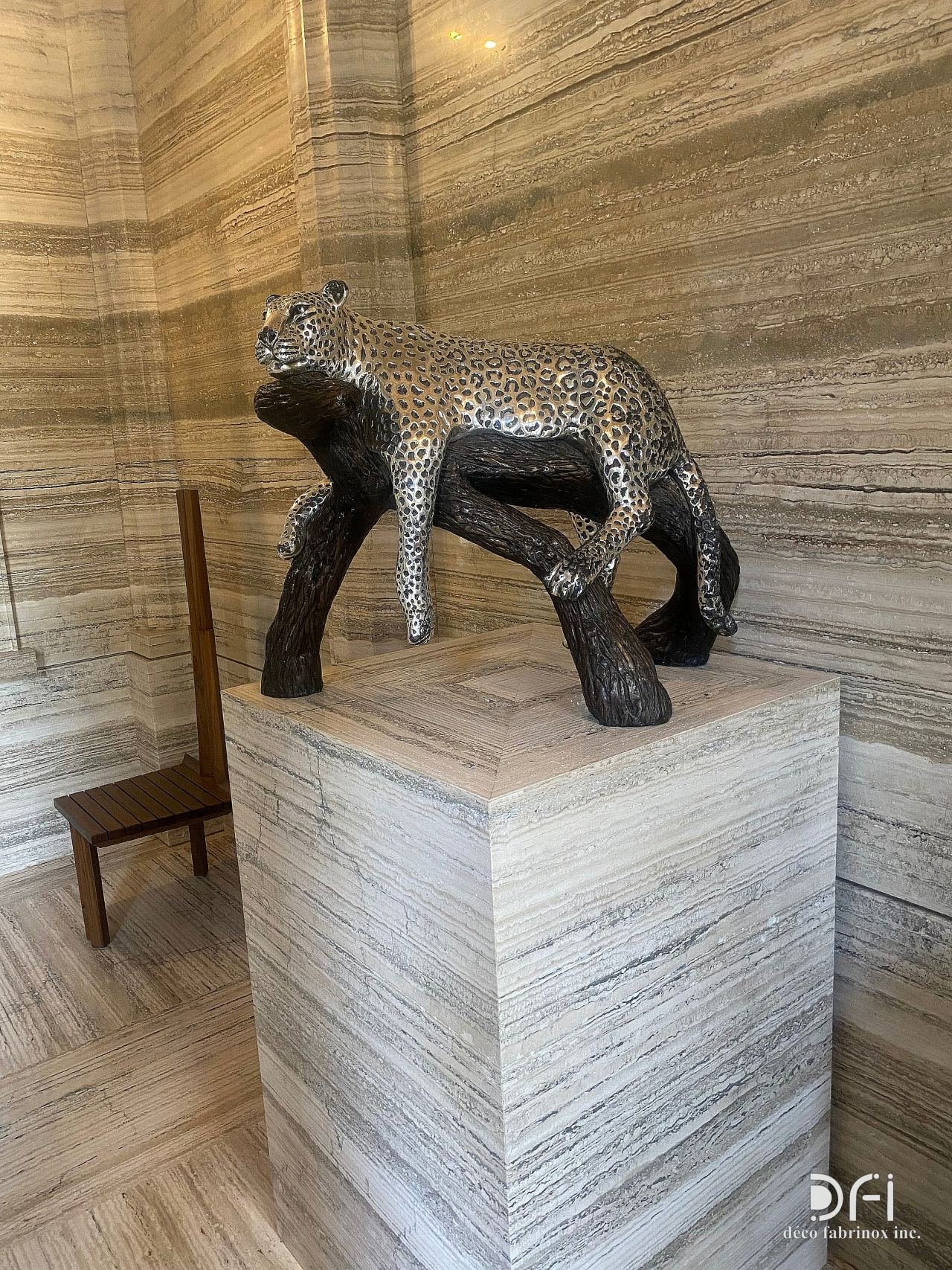 Metal leopard sculpture on a stone plinth