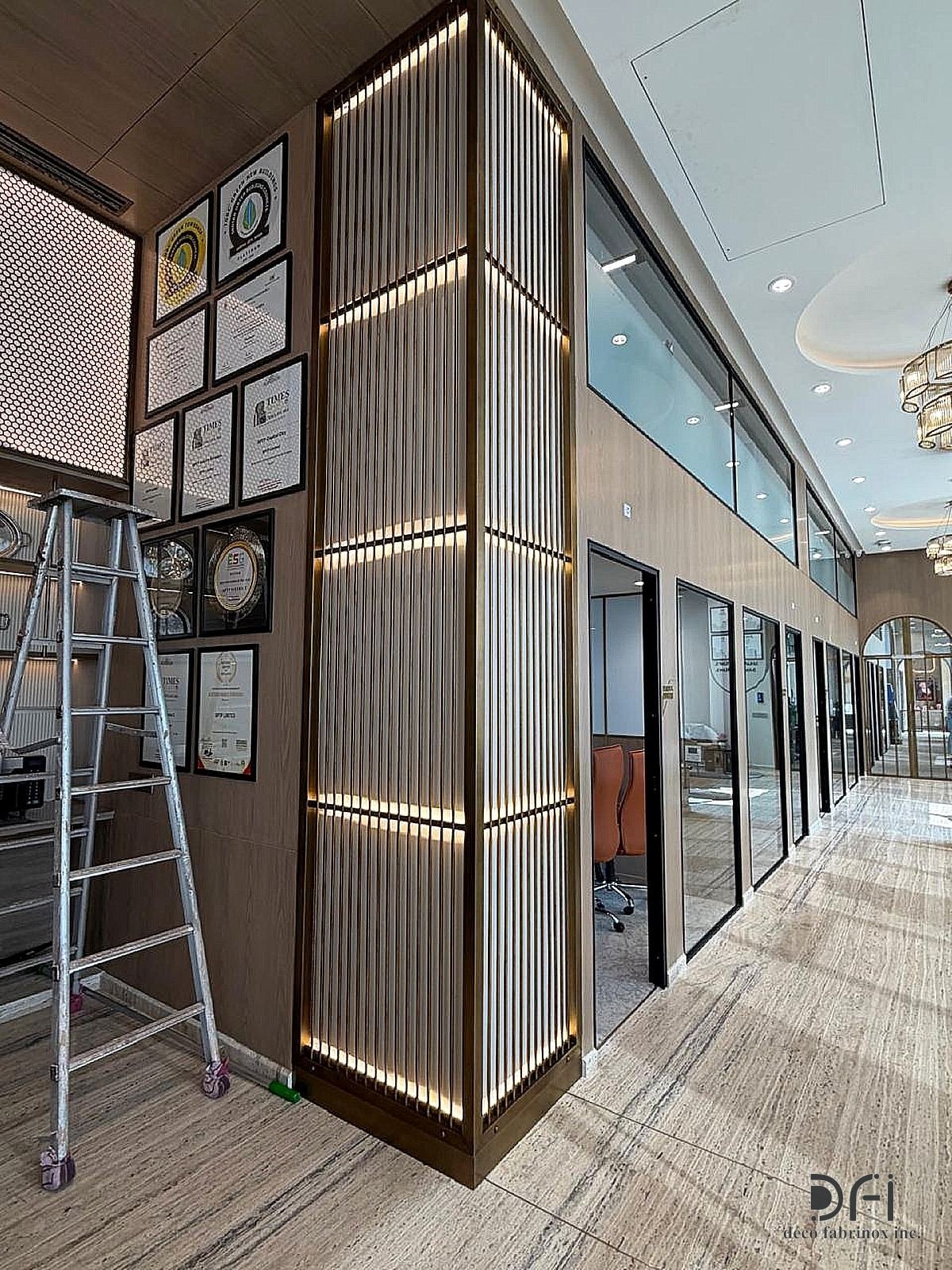 Lit metal slat cladding around a column in a corridor