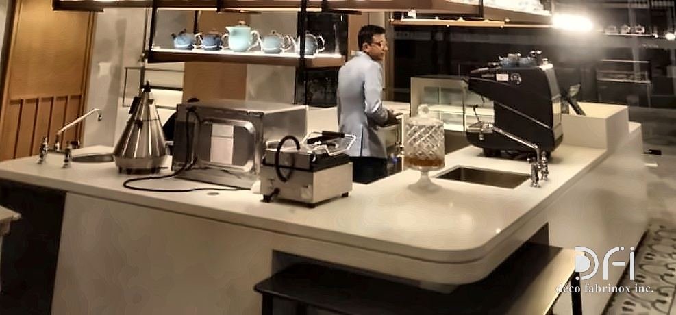 Barista counter beneath a slim metal canopy structure