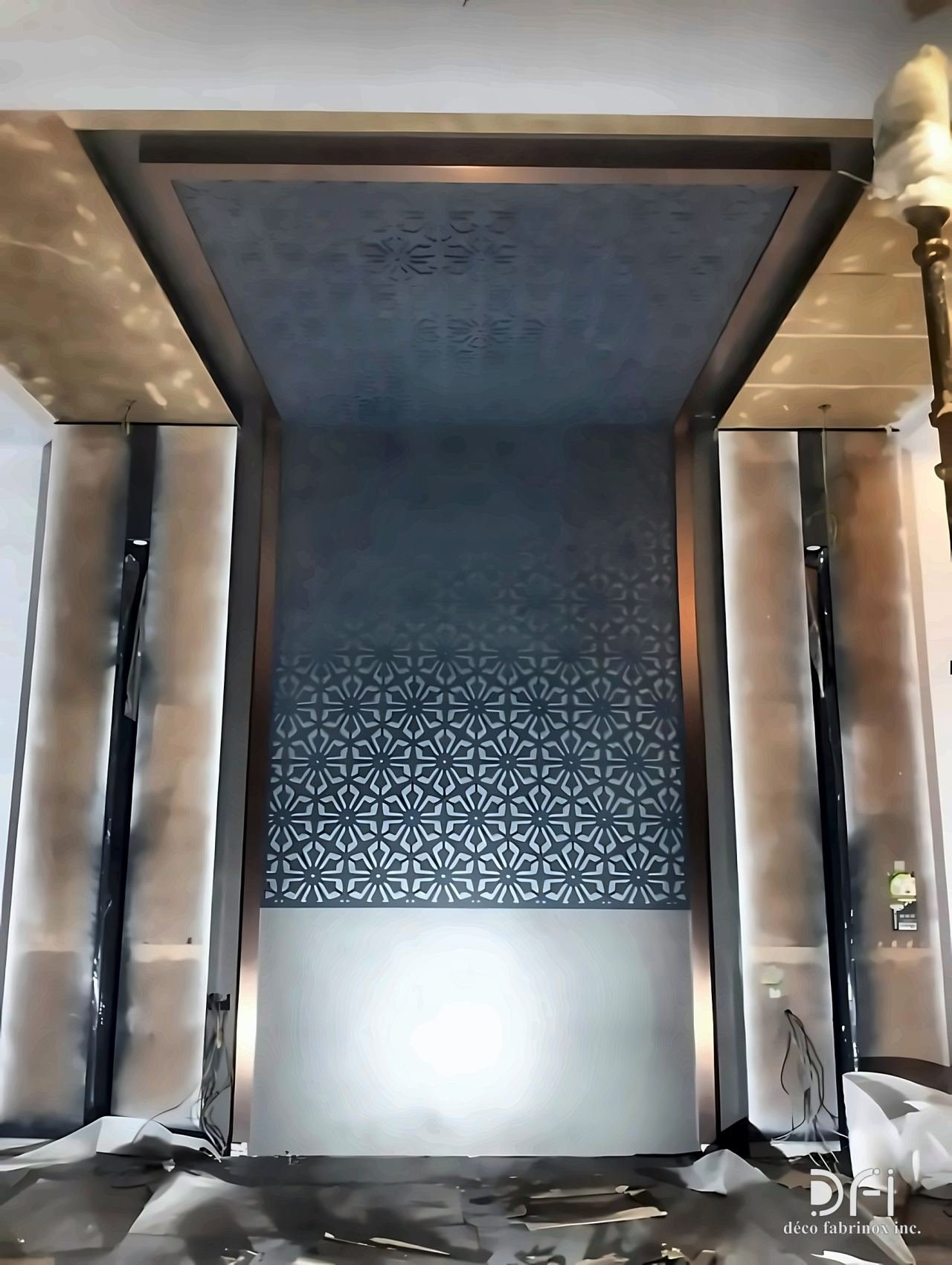 Laser-cut metal panels lining a lift car
