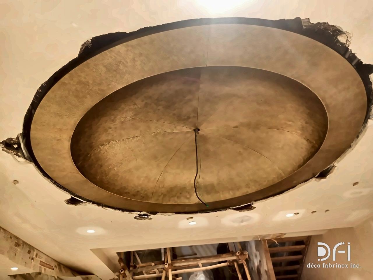 Domed brass ceiling feature during installation
