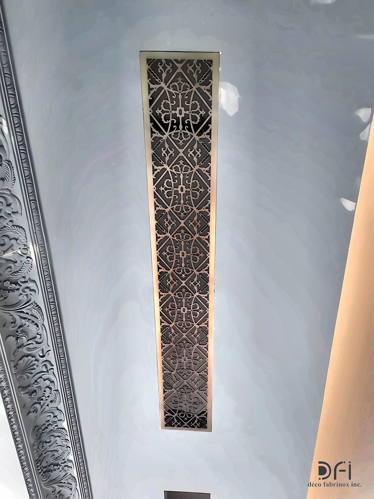 Laser-cut metal ceiling strip in a white soffit