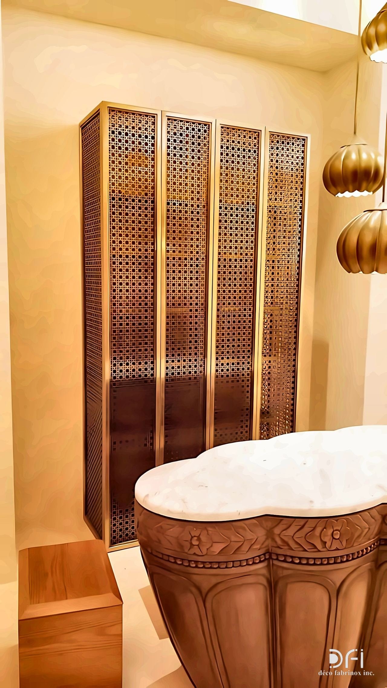 Perforated bronze cabinet doors beside a sculpted vanity