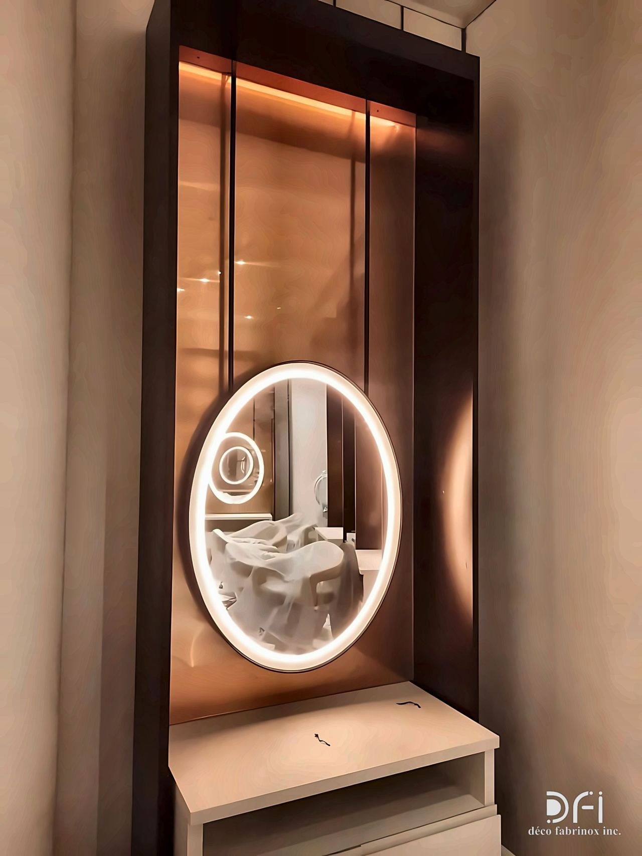Bronze-framed backlit vanity niche with a round mirror