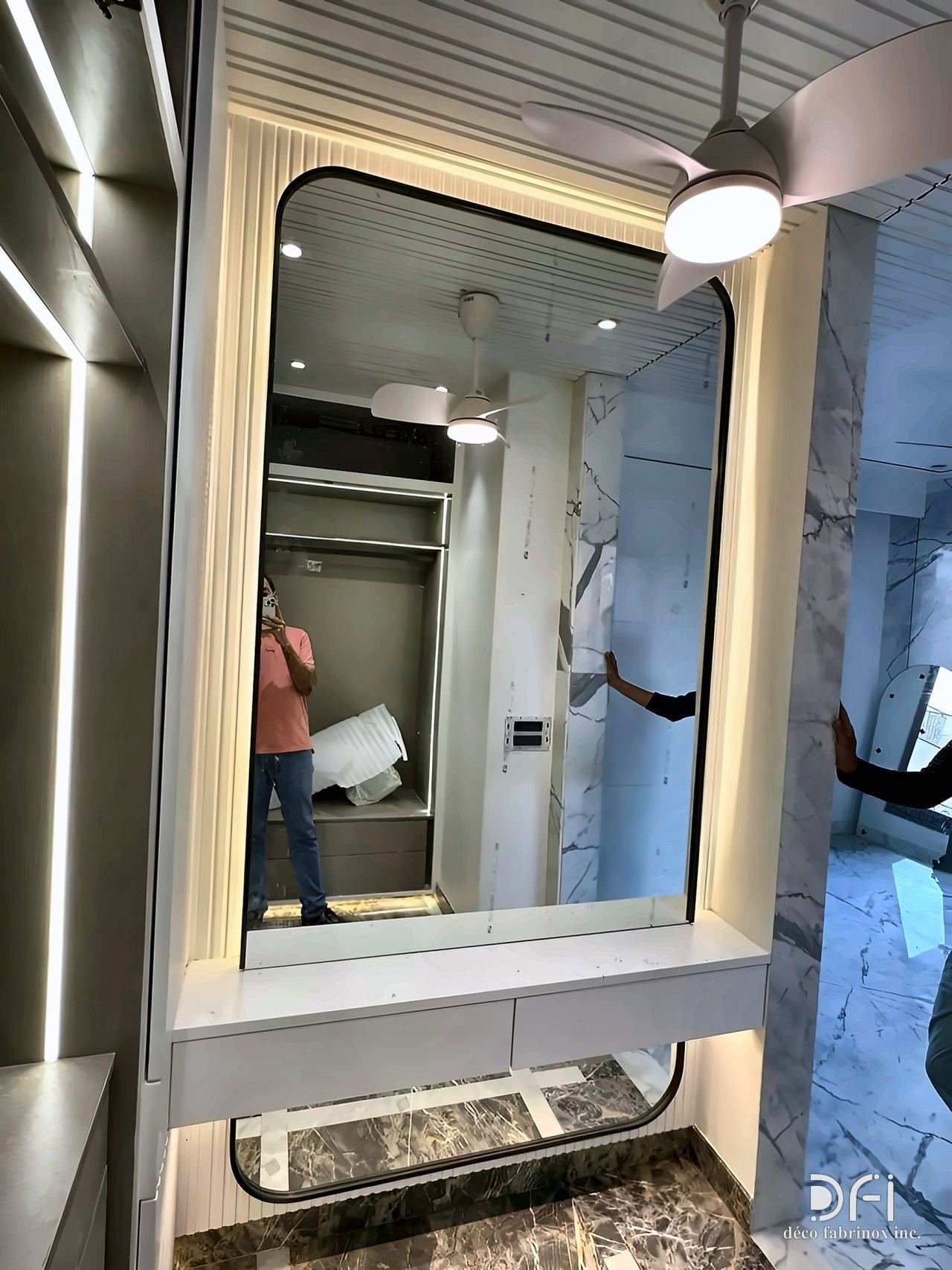 Backlit rounded mirror frame above a vanity