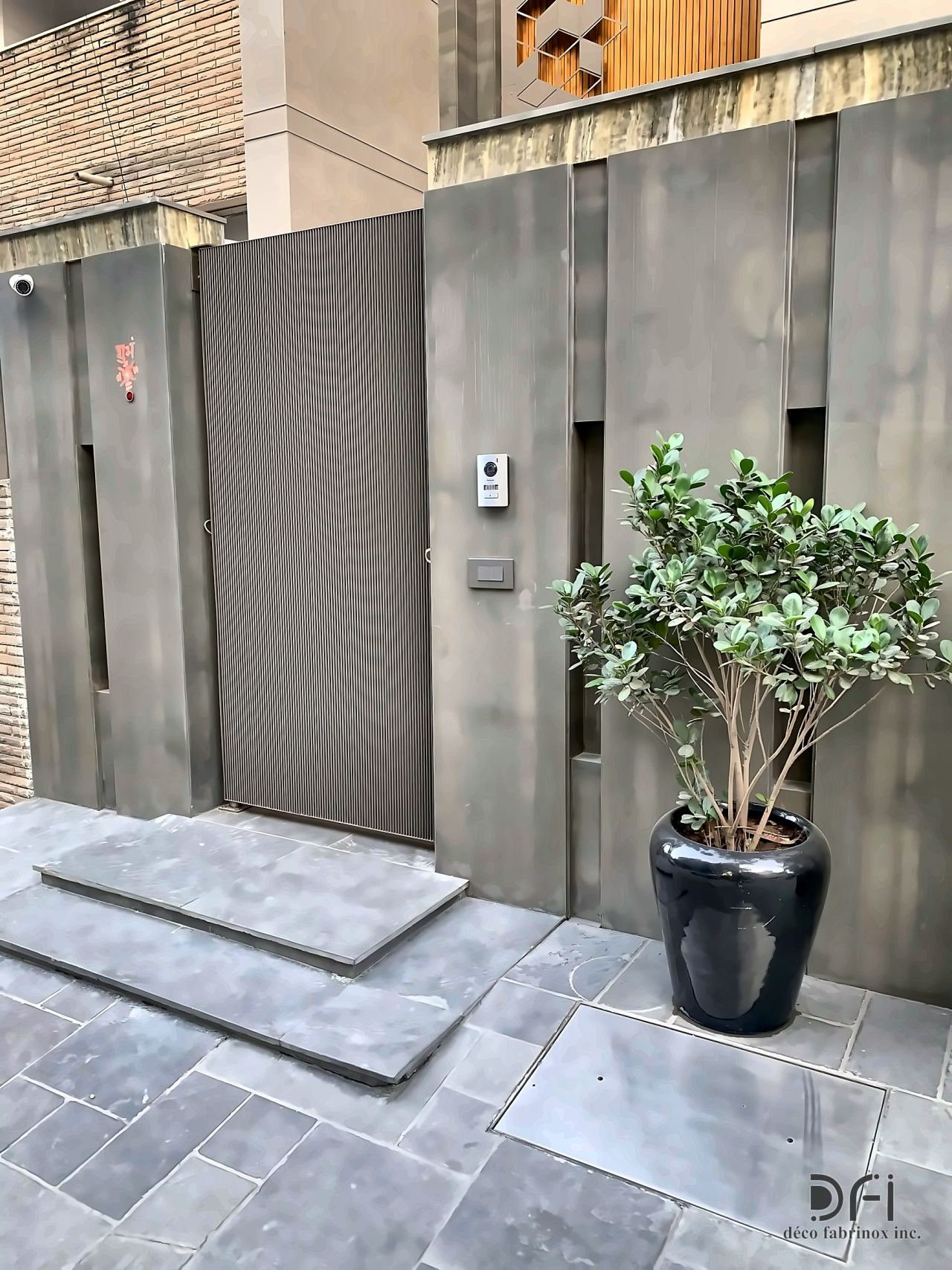 Grey metal-clad entrance wall and gate