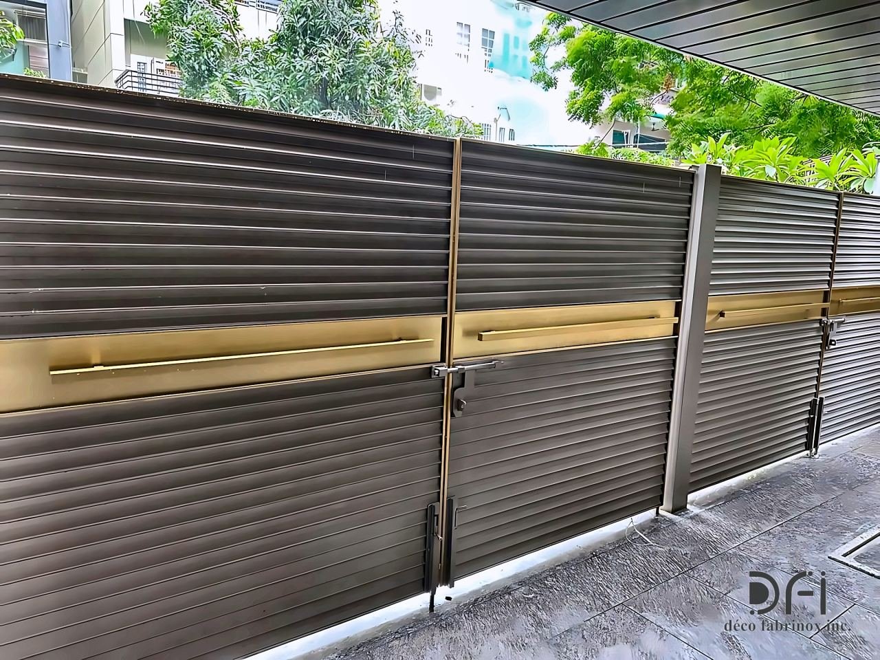 Louvred gate panels with a brass handle band, seen from the street