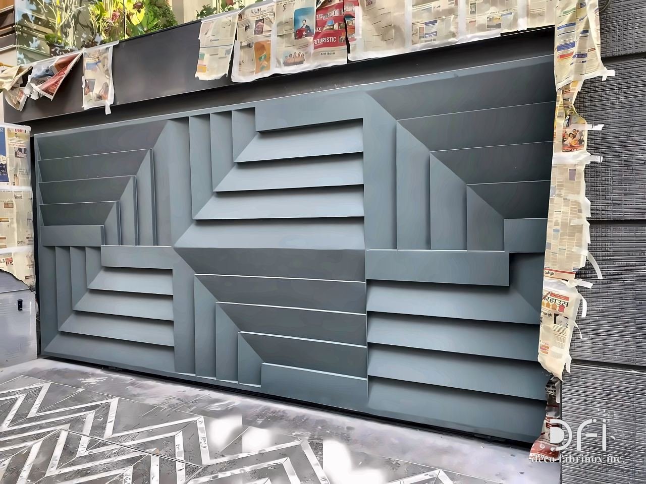 Grey faceted metal gate with stepped geometric relief