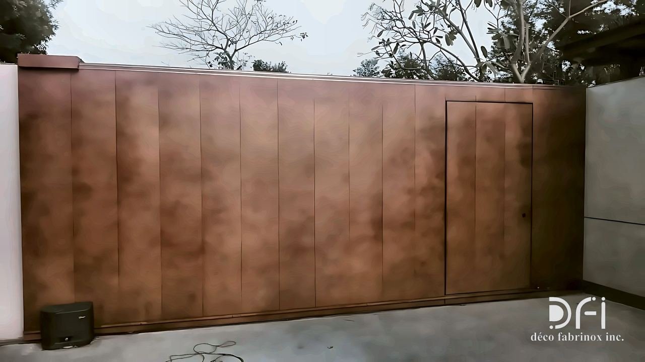 Copper-toned clad sliding gate with a wicket door