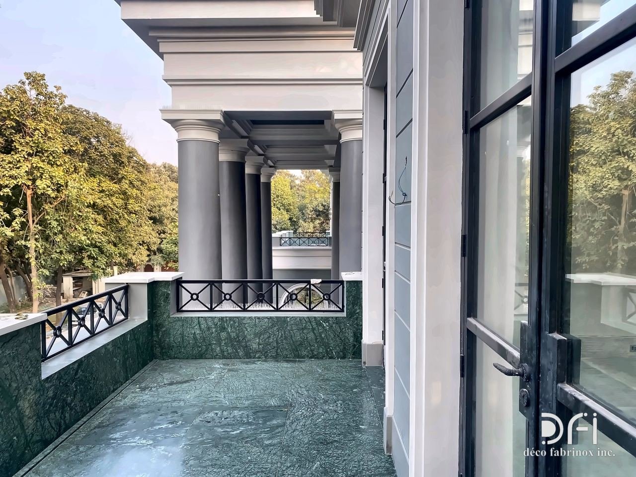 Black metal railings on a colonnaded balcony