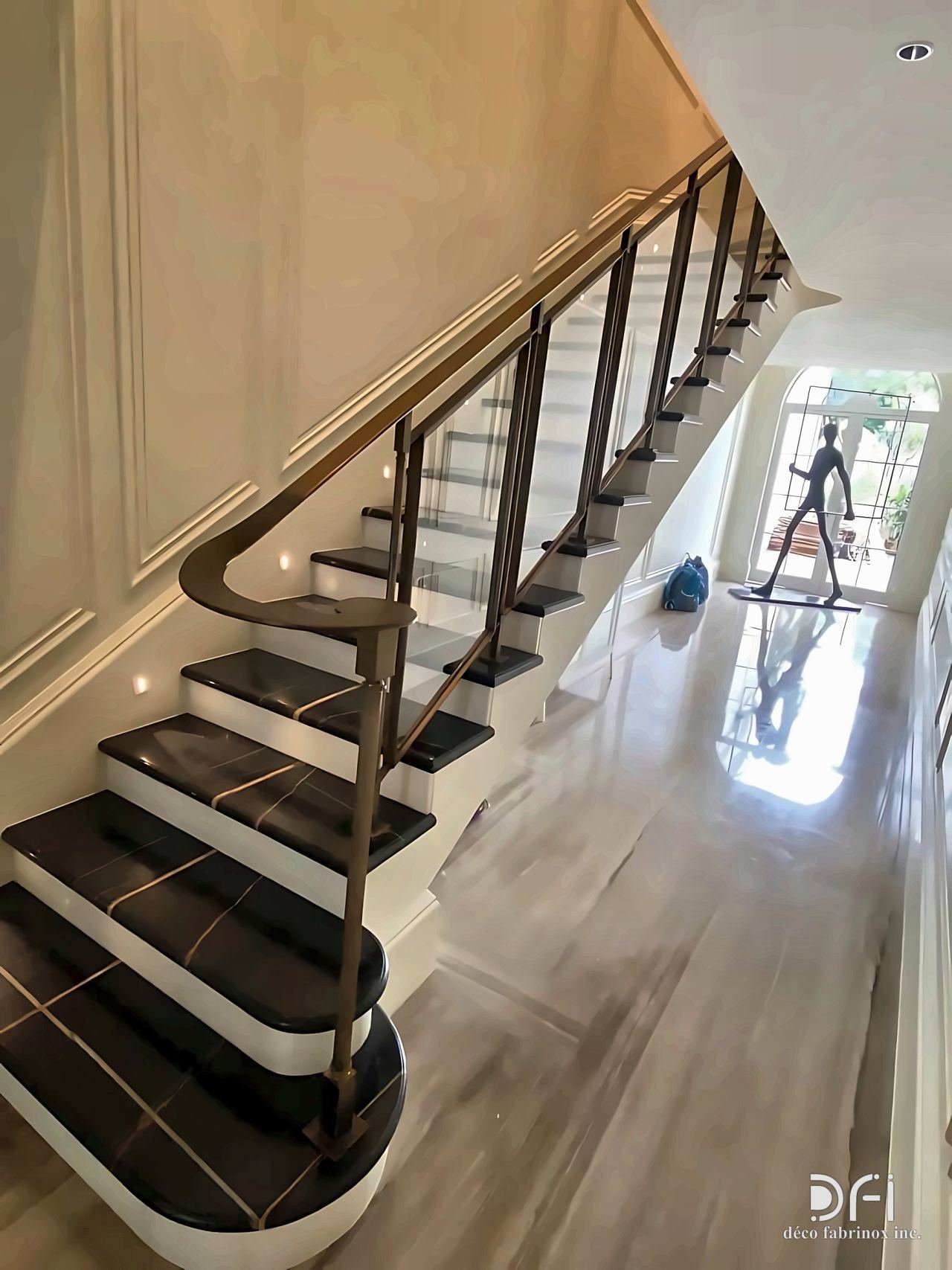 Bronze balustrade with a timber handrail on a curved staircase