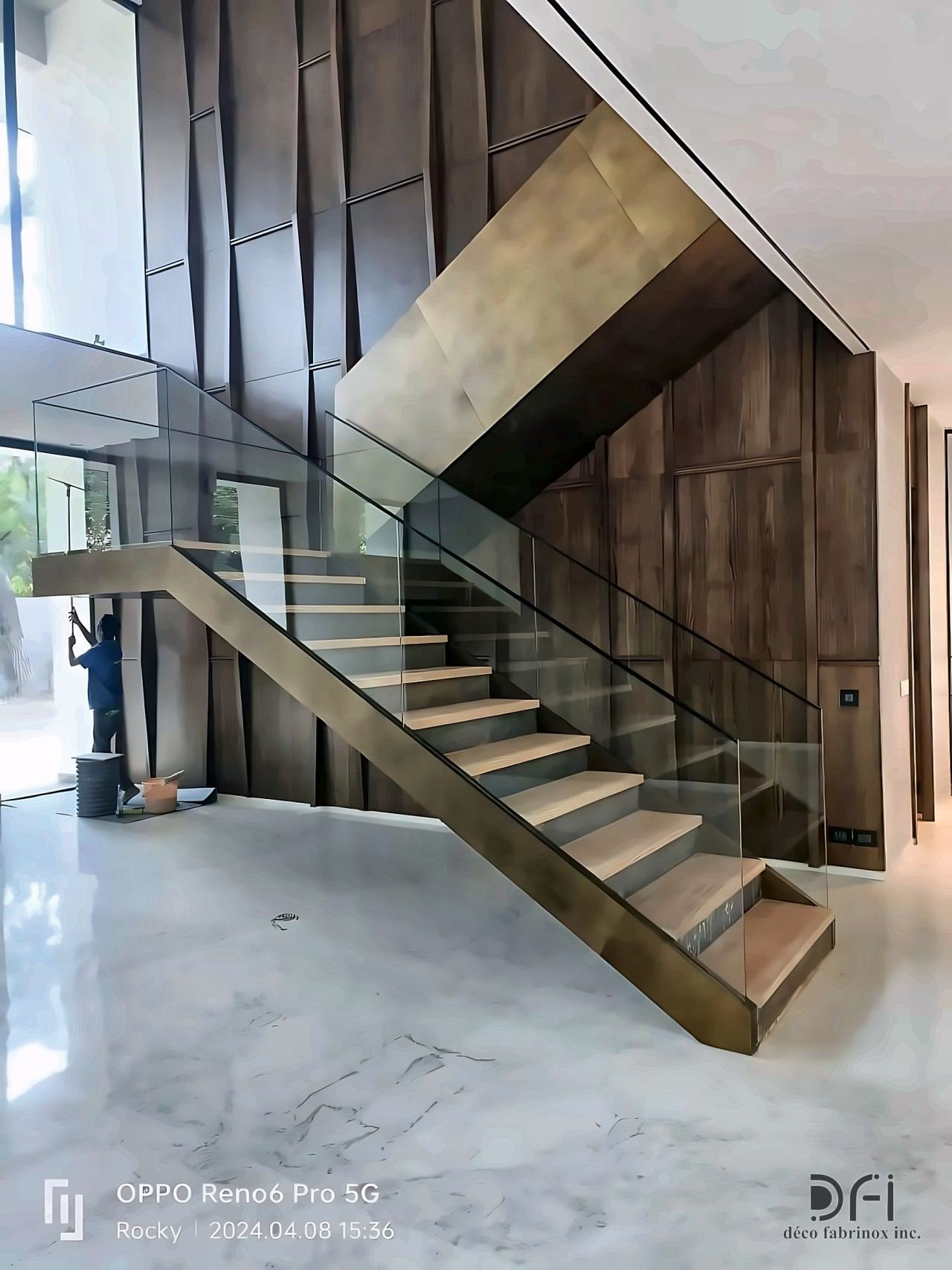 Bronze-clad cantilevered staircase with a glass balustrade