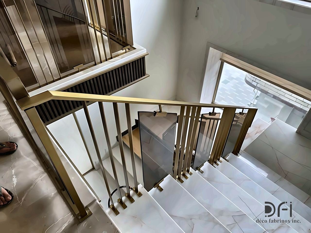 Brass balustrade with slim balusters on a marble stair