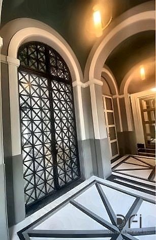 Metal screen doors set in an arched entrance