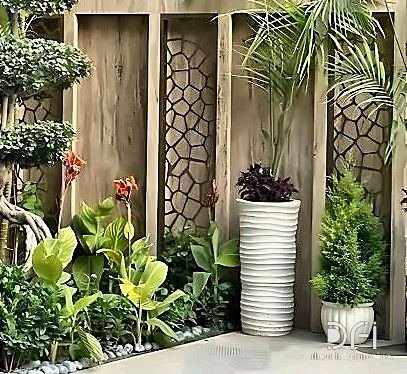 Metal screen panels on a planted courtyard wall