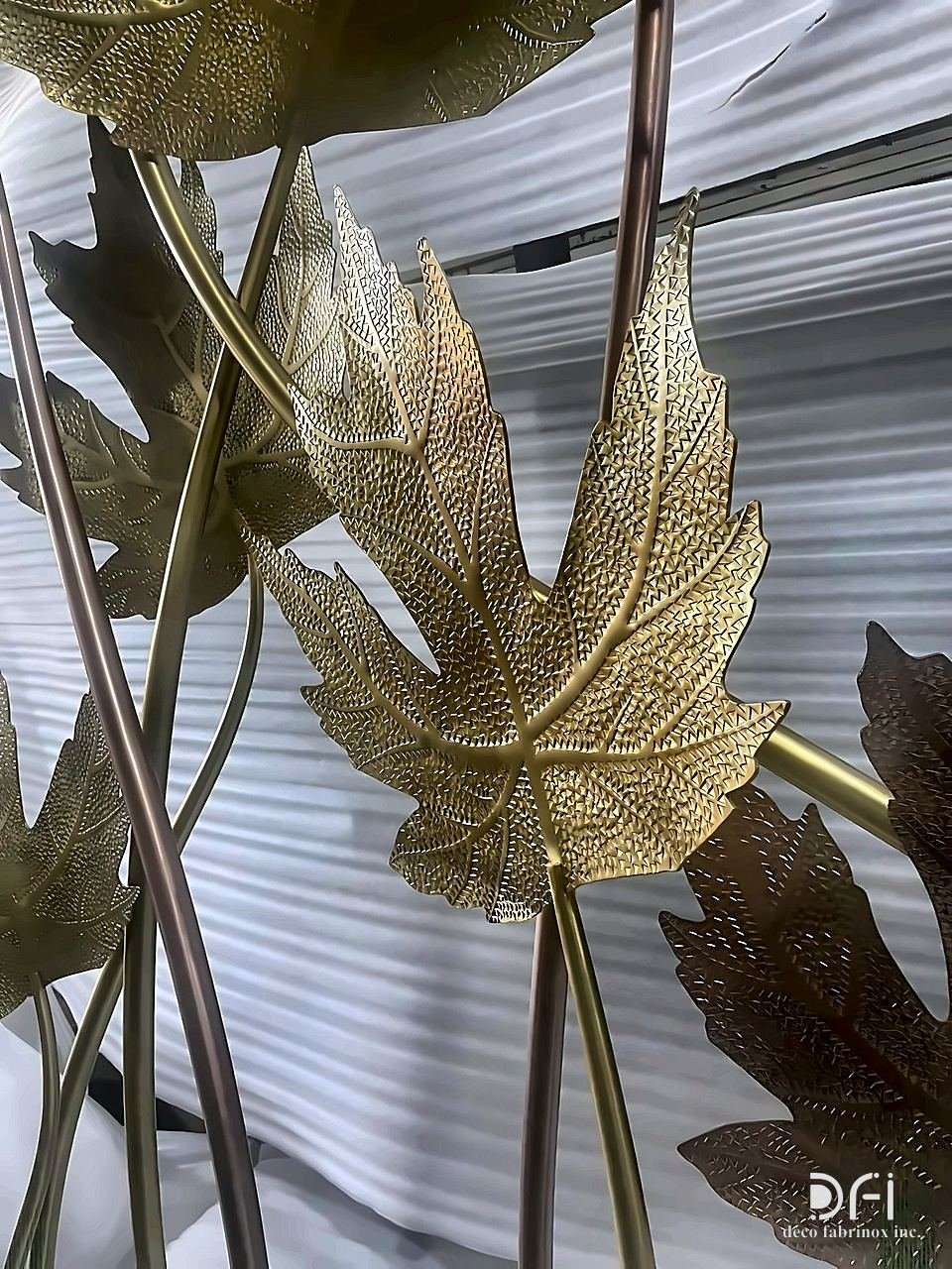 Close-up of brass and copper maple leaves on stems