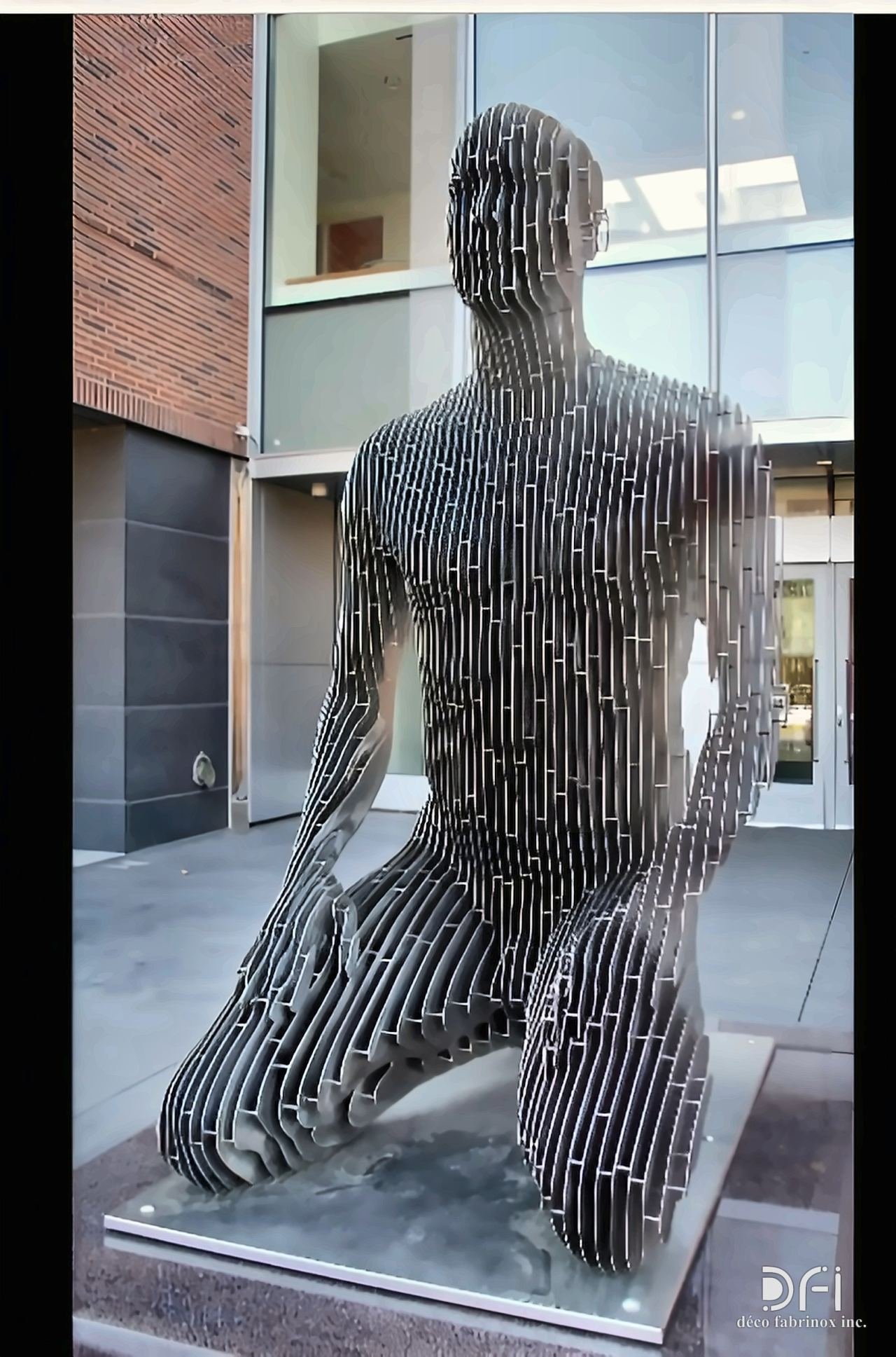 Kneeling figure built from stacked steel profiles
