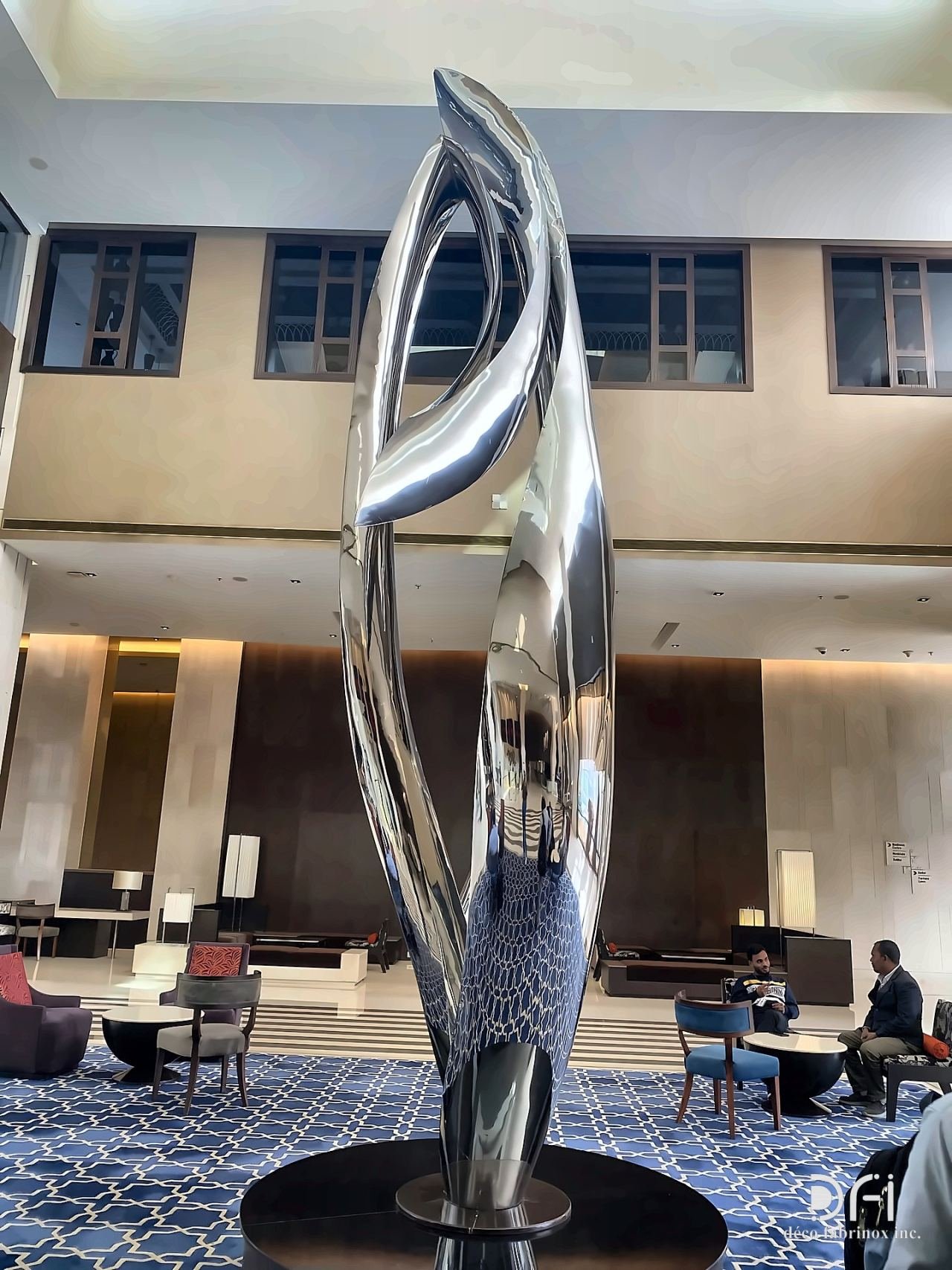 Polished steel twisting sculpture in a hotel lobby