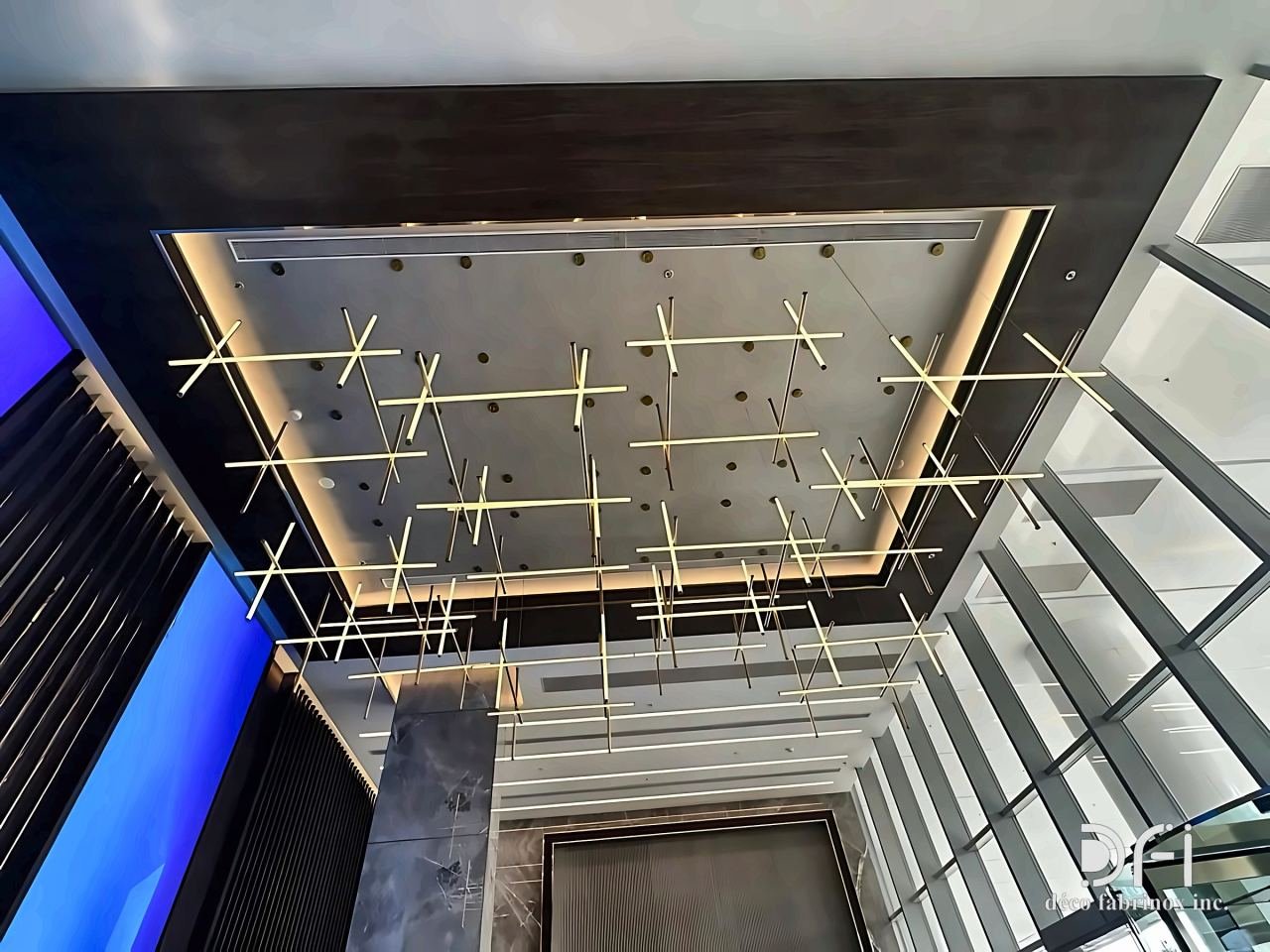Brass rod ceiling installation in a glazed atrium
