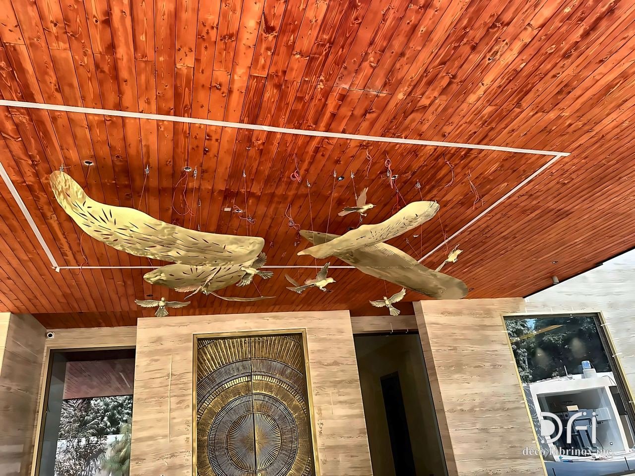 Brass birds suspended from a timber ceiling
