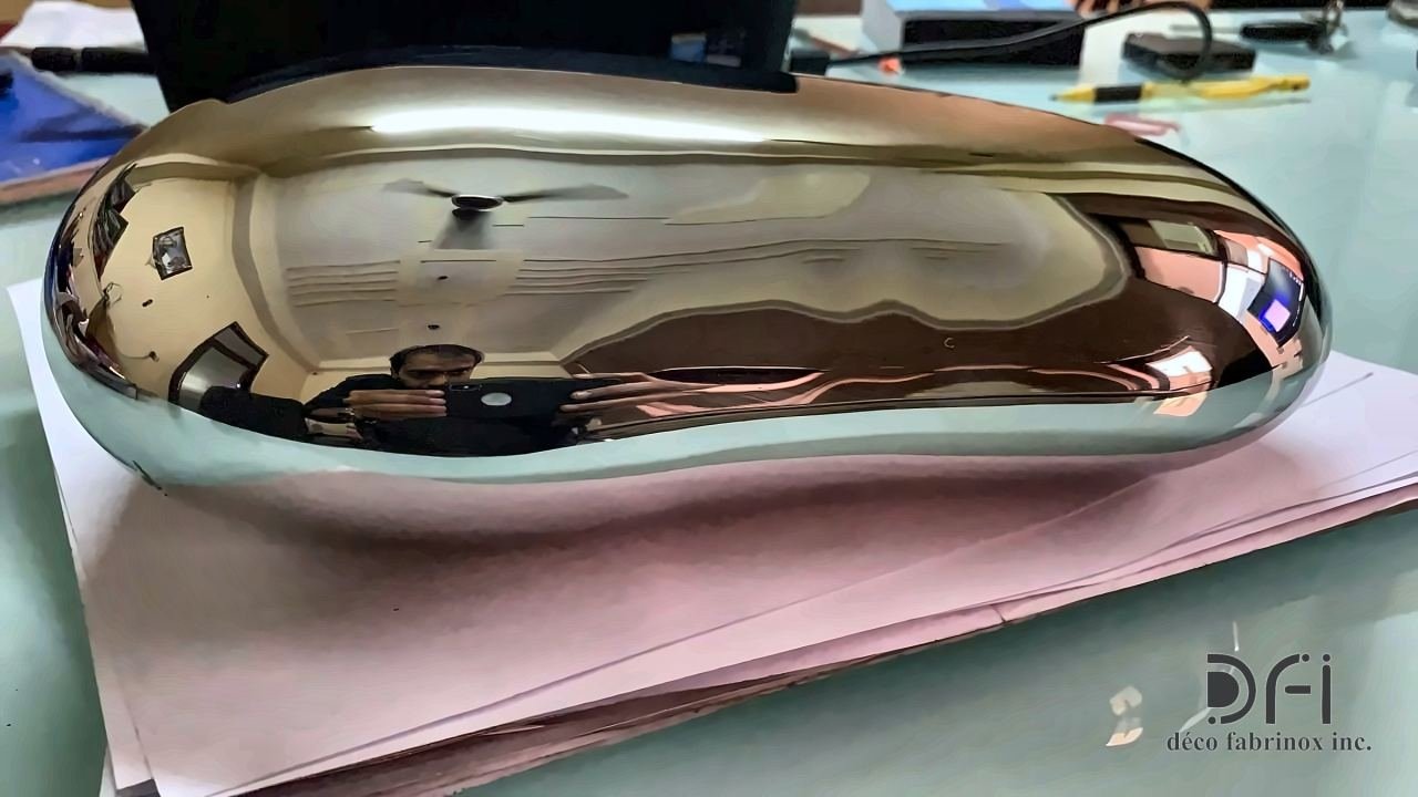 Mirror-polished stainless steel pebble sculpture