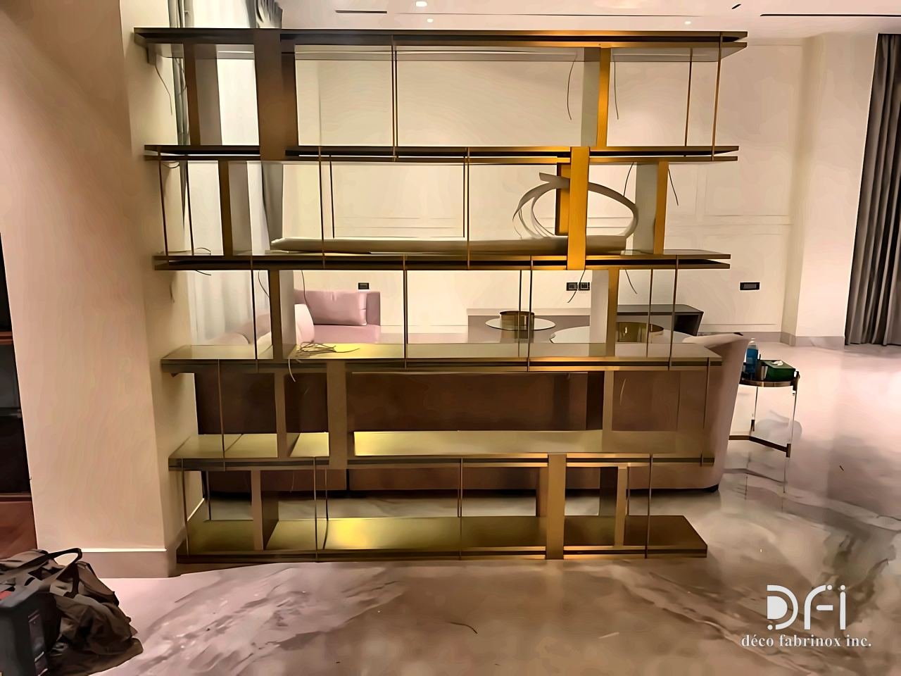 Freestanding brass and bronze shelving unit with open frames